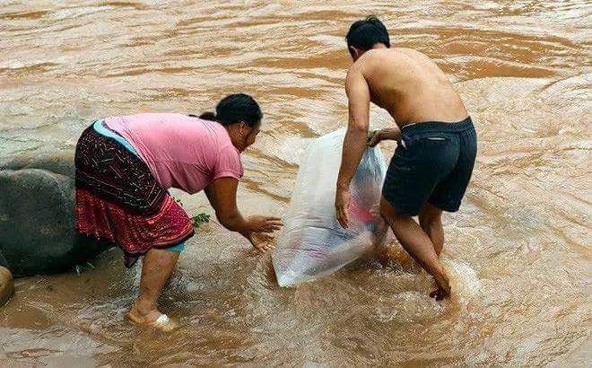 Villagers from the northern mountainous region of Huoi Hua in Vietnam were photographed and filmed taking their children to school across a river in huge plastic bags.