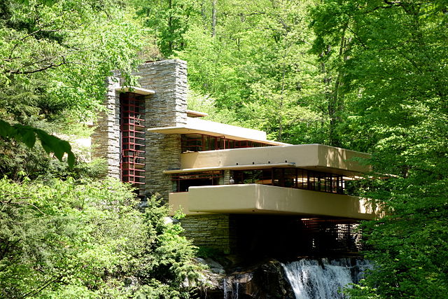 Fallingwater, one of Frank Lloyd Wright’s most famous buildings, exemplifies many biophilic features. The home has human-nature connectivity through the integrative use of the waterfall and stream in its architecture - the sound from these water features can be heard throughout the inside of the home. This allows visitors to feel like they are “participating” in nature rather than “spectating” it like they would be if the waterfall were downstream. In addition, the structure is built around existing foliage and encompasses the local geology by incorporating a large rock in the center of the living room. There are also many glass walls to connect the occupants to the surrounding woods and nature that is outdoors. To better the flow of the space, Wright included many transitional spaces in the home (porches and decks); he also enhanced the direct and indirect experiences of nature by using multiple fireplaces and a wealth of organic shapes, colors, and materials. His use of Kellert's biophilic design principles are prominent throughout the structure, even though this home was constructed before these ideas were developed.