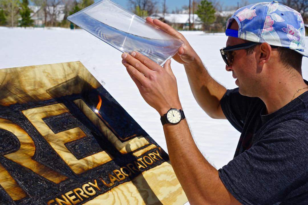 Using a Fresnel lens, the artist scorches an image into wood by magnifying the sun’s rays.