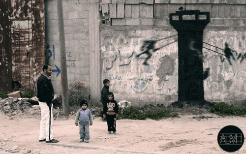 Children swinging from a watchtower in Gaza. By Banksy
