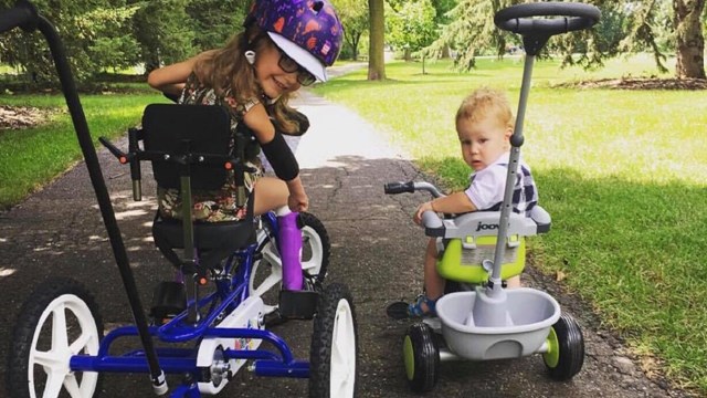 Lila’s mother, Aimee Jordan, says the bike has given Lila independence. Aimee points to a cul-de-sac up the street from the family’s Plymouth home. “She gets to show off over there while all the kids are outside, riding her bike and not her wheelchair,” Aimee says.