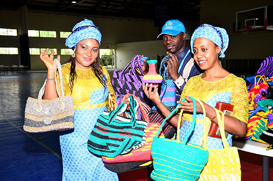 A display of colourful crocheted bags and accessories made from recycled plastic waste.