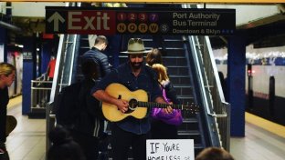 Why this busker encourages people to take money from his collection