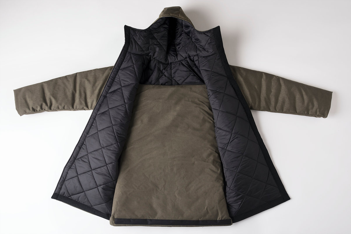 The EMPWR coat is a water-resistant jacket, which can transform into a sleeping bag, or be worn as an over-the-shoulder bag when not in use. The coat is constructed of durable, water resistant Cordura fabric from Carhartt, upcycled automotive insulation from General Motors, and other materials provided by generous donors.
