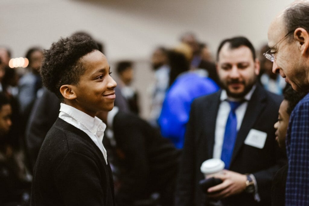 “There were so many volunteers, that at times I saw young men huddled in the center of 4-5 mentors. The look of awe- even disbelief- in students’ eyes as they made their way through the crowd of ‘Dads’ was astonishing.”