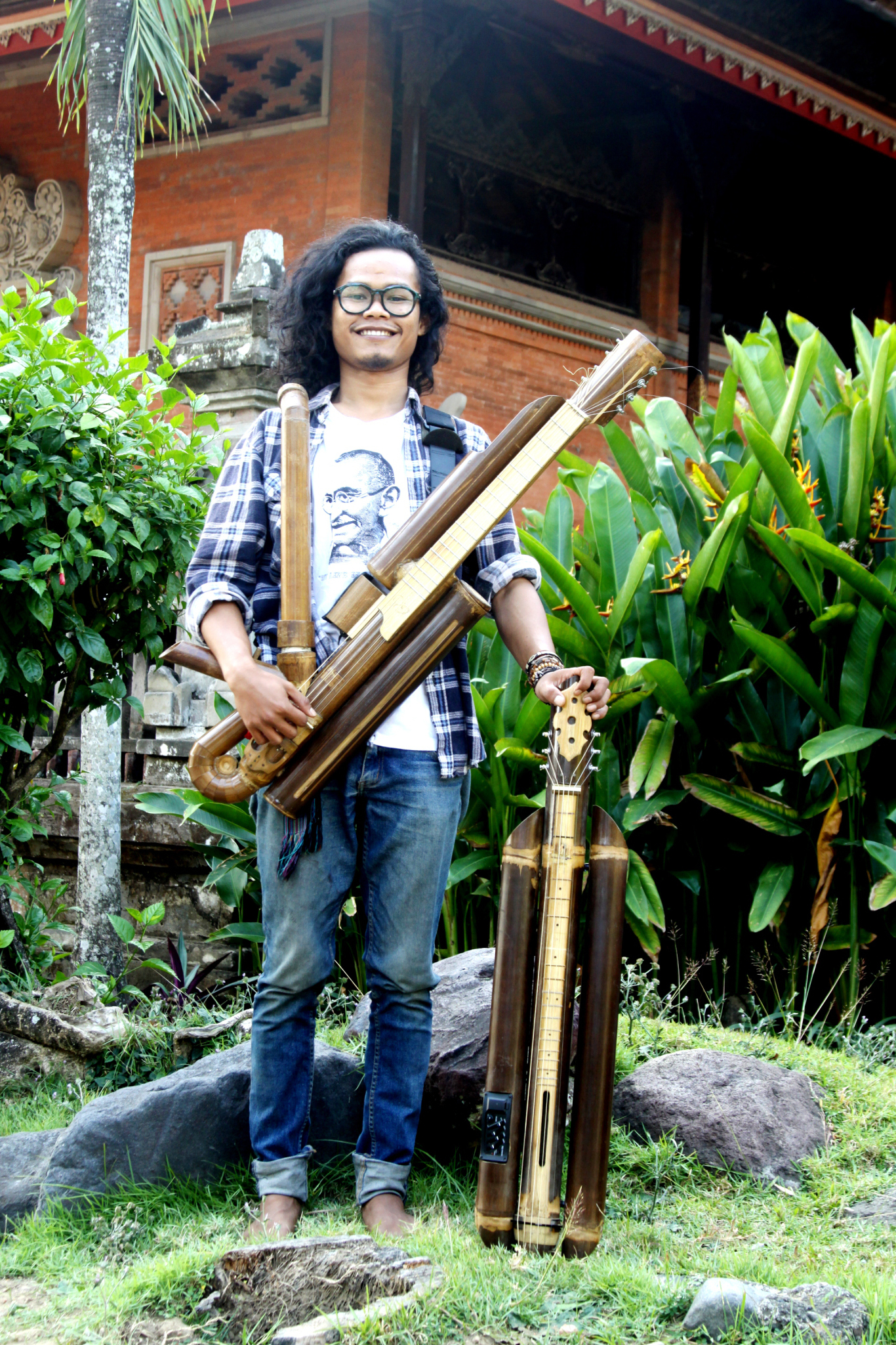 Rizal pictured here with a Rasendriya and a bamboo lap steel guitar, and wearing spectacle frames he fashioned himself from, you guessed it, bamboo!