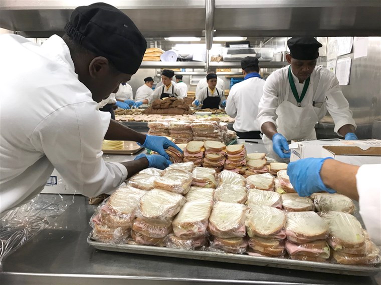 On Friday, the ship's kitchen staff prepared some 10,000 meals, while guests volunteered to plate and pack them. The ship was a hive of activity as the crew pulled double-duty.
