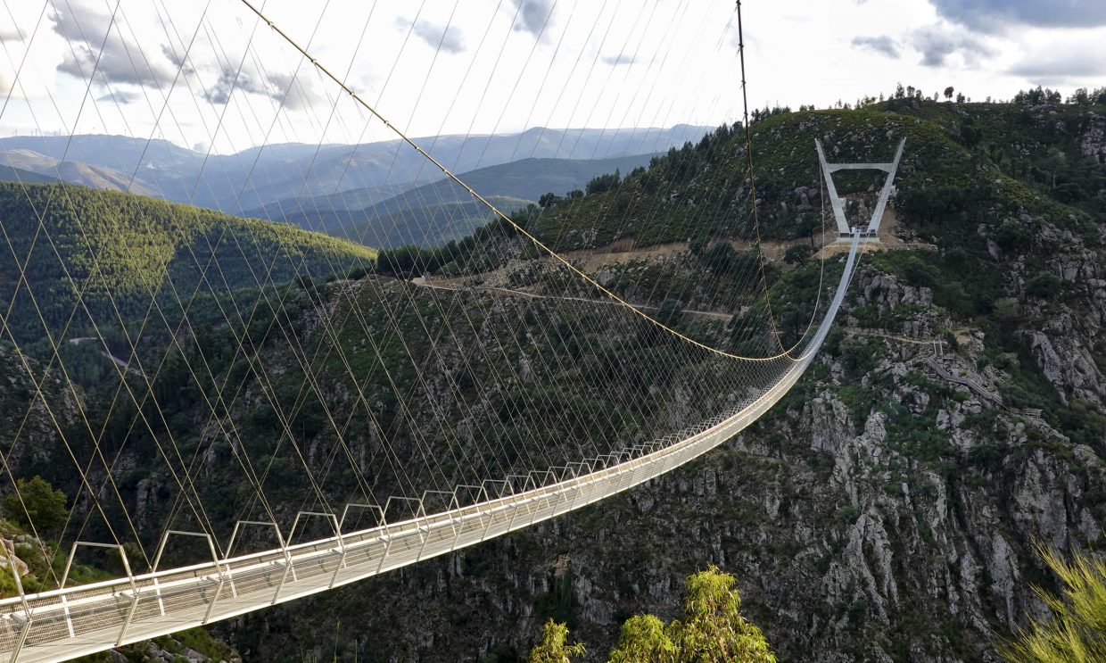 It’s a Tibetan-style hanging bridge, held up by steel cables and two huge V-shaped towers.