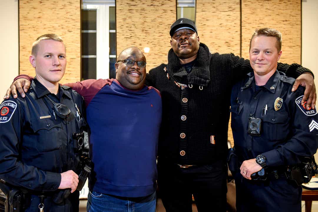 Kobie Johnson, second from left, poses with, from left, East Lansing Police Officer Andrew Stephenson, Aurelio Todd and East Lansing Police Sgt. Erich Vedder on Wednesday, Nov. 20, 2019, at Johnson's home in East Lansing. Johnson was saved by the three men after suffering a cardiac arrest while in his car on Burcham Drive on Sept. 26.