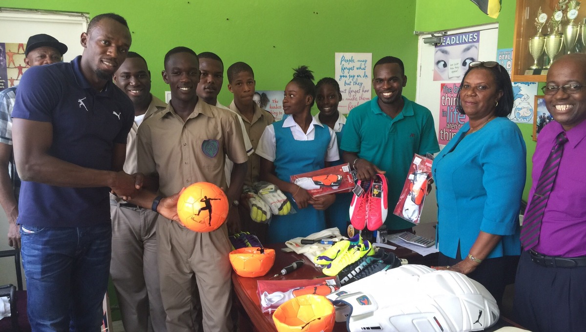 Bolt donating sports equipment to his former school