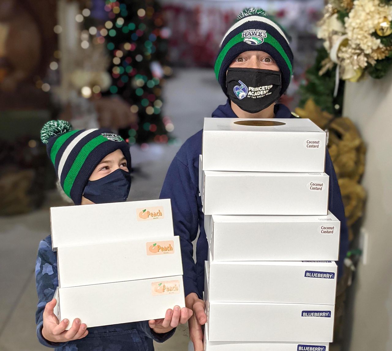 Sandro Cunningham, 11, right, gets help delivering pies from his brother Crescenzo, 7, at the Trenton Area Soup Kitchen on Nov. 25, 2020, the day before Thanksgiving.