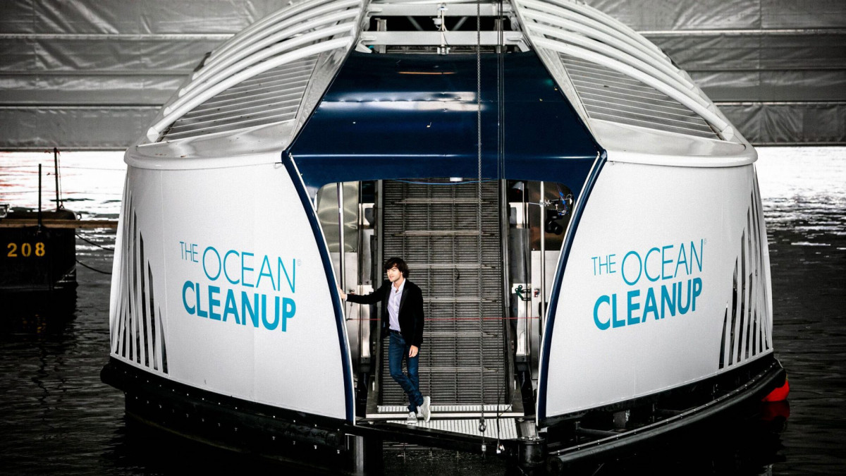Boyan Slat, founder of The Ocean Cleanup poses in front of the conveyor belt in the interceptor during the unveiling in Rotterdam, 27 October 2019