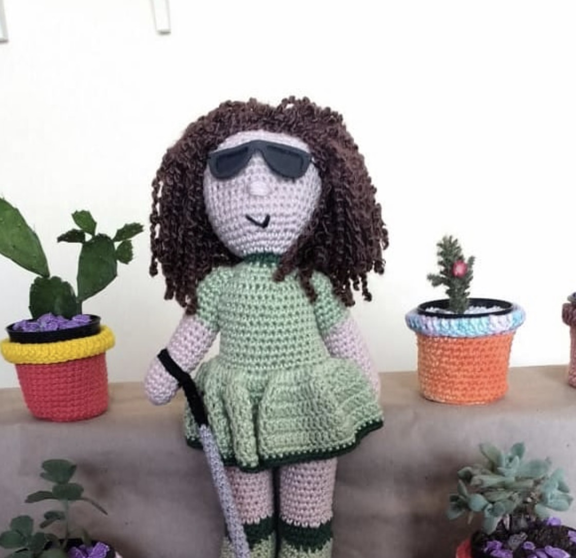 This cuddly companion with curly locks comes complete with cane and dark glasses, just like her new owner.