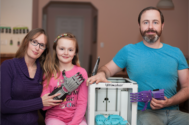 Ivan, Jen, a 3D printer and a proud new owner of an e-NABLE prosthetic hand